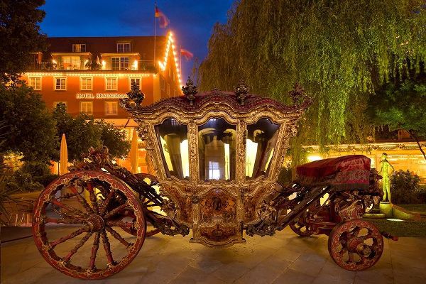 Germany-Lindau Island-Lake Constance Victorian ornate carriage in front of hotel at night